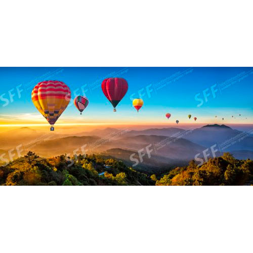 Colorful hot air balloons flying over mountain in Thailand.
